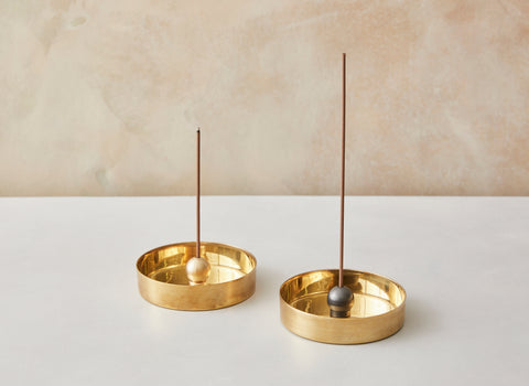 A charming modernist design, the brass sphere (available in natural brass or black patina ) sits upon a ring allowing you to pivot the incense in any direction.